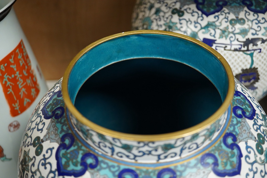 A pair of Chinese blue and white dragon decorated cloisonné enamel jars and covers on stands, 45cm high and a Japanese enamelled porcelain vase, early 20th century. (3). Condition - good